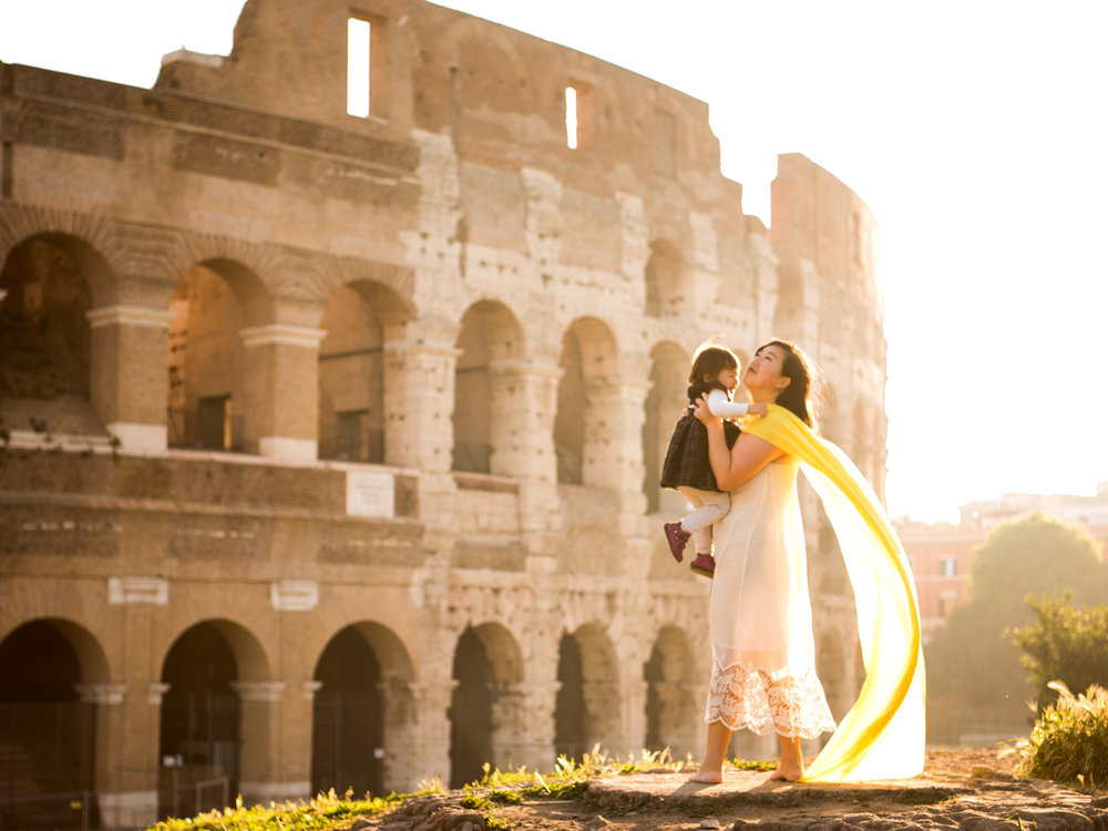 Picking Lisa up for a family travel photo in front of the roman colosseum.