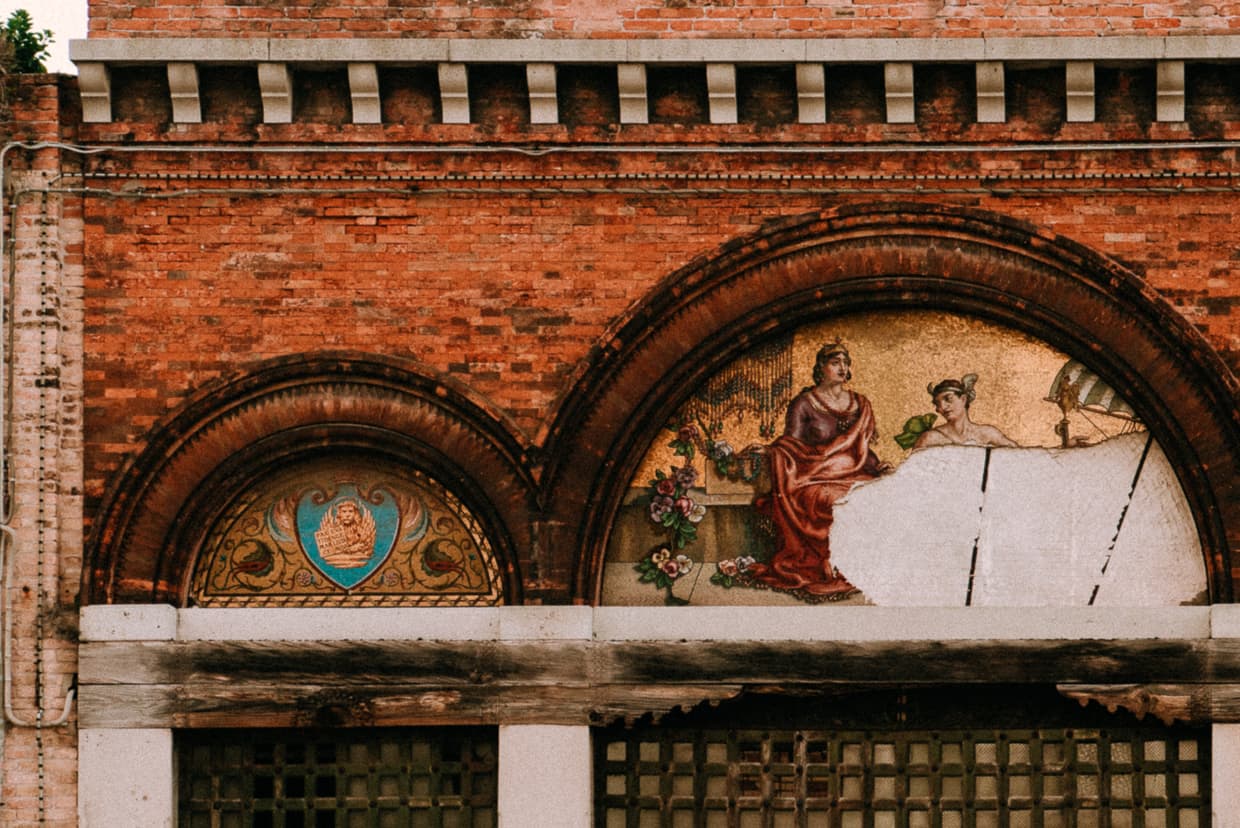 A mural over windows on the island of Murano, Italy.