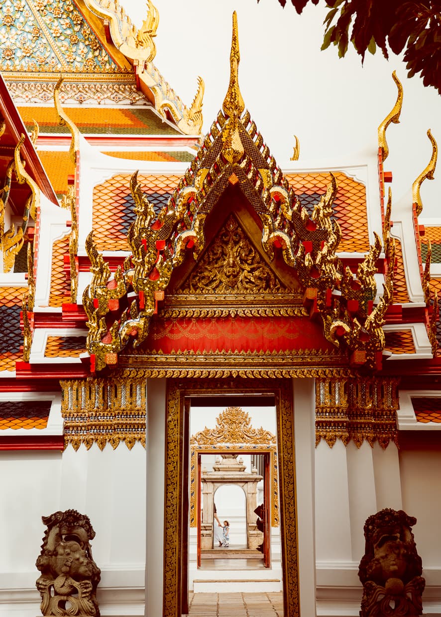 A door frame with Phra Ubosot in the background. Wat Pho.