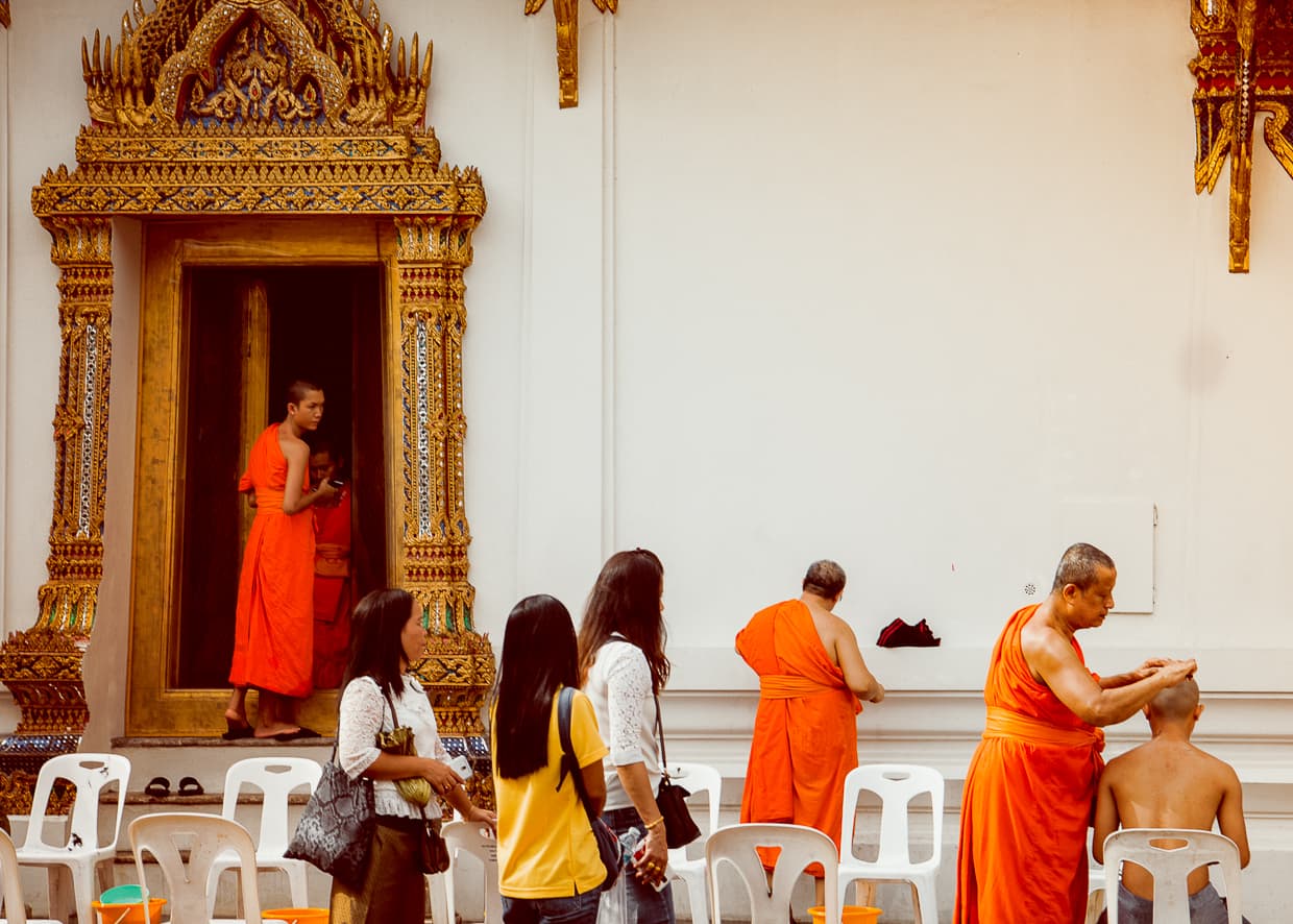 Buddhist Monks getting their heads shaved.