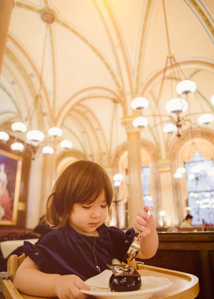 Lisa eating a cake in Cafe Central.