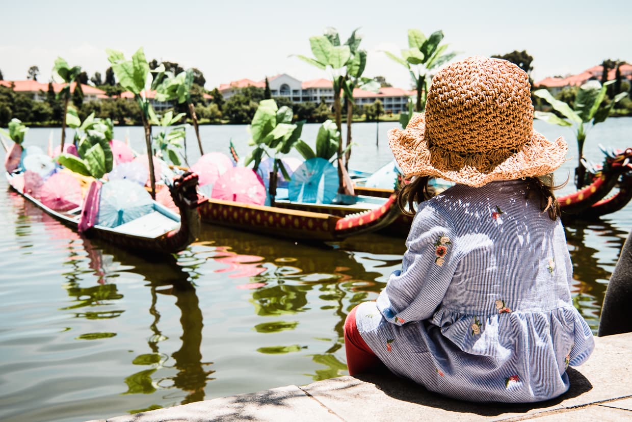Sitting by dragon boats in the Dai Village in Kunming, China.