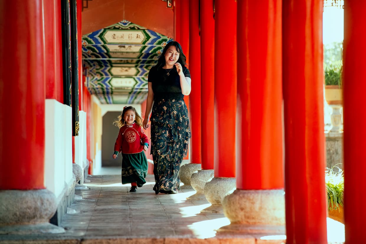 Walking down a corridor of red columns in a Chinese Palace.