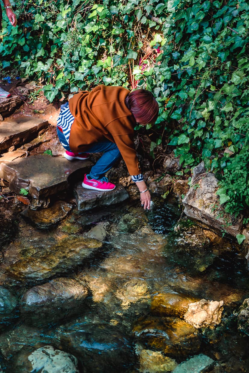 Drinking spring water from the Black Dragon Pool.