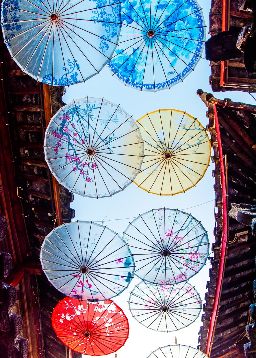 Umbrellas hanging over a street near the center of the Lijiang Old Town.