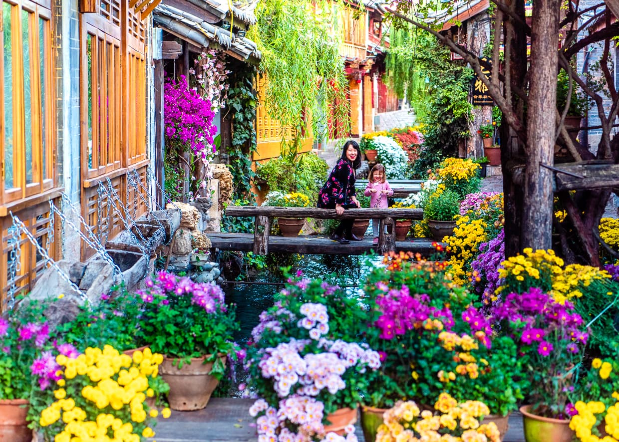 A Lijiang Old Town river decorated with flowers.