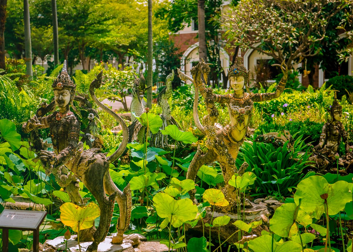 Statues in the tropical gardens at the Erawan Museum in Bangkok, Thailand.