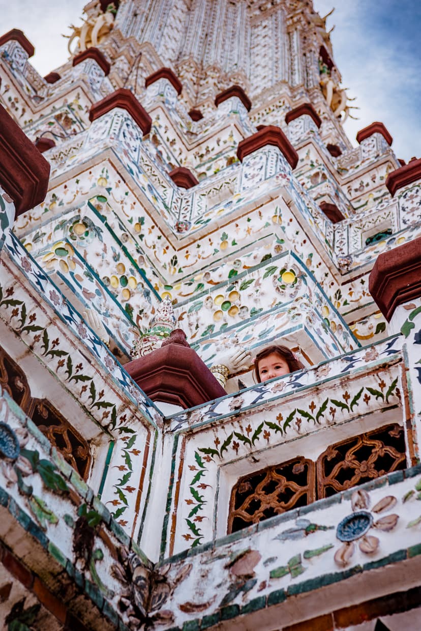 Girl looking down from spire of Wat Arun.