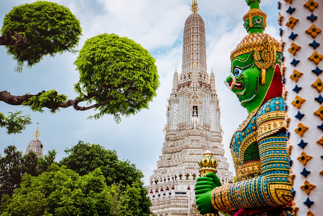 A statue guards Wat Arun in Bangkok, Thailand.