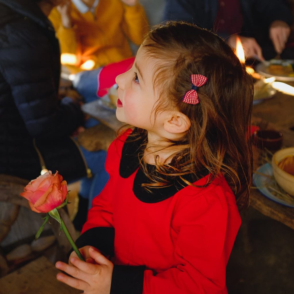 Lisa holding a rose at Christmas Brunch.