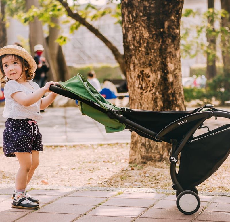 Toddler playing with the Babyzen Yoyo Travel Stroller.