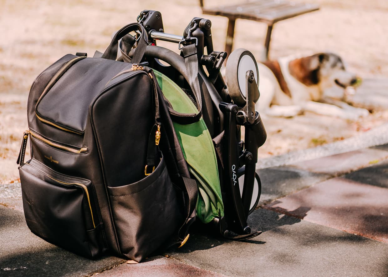 The Babyzen Yoyo Travel Stroller folded next to our diaper bag.