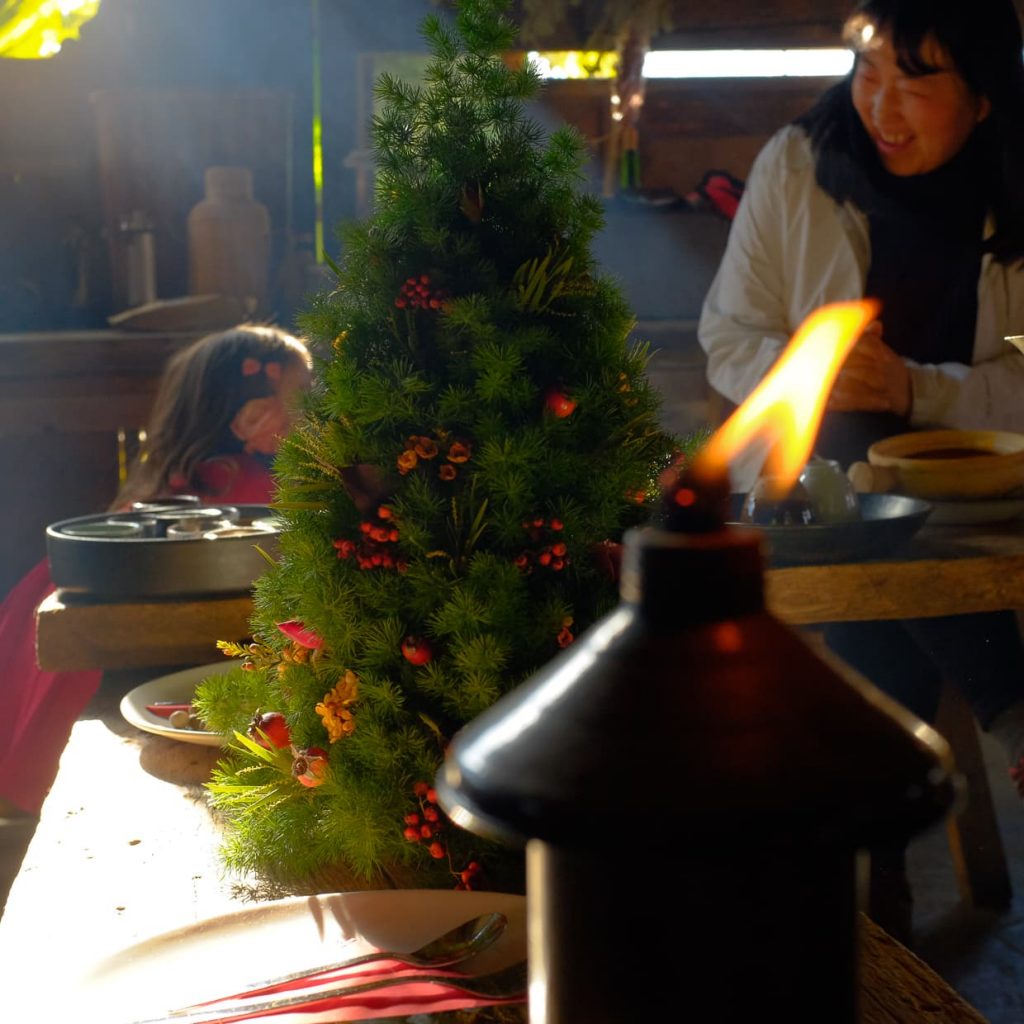 A candle and Christmas tree in Dali, China.
