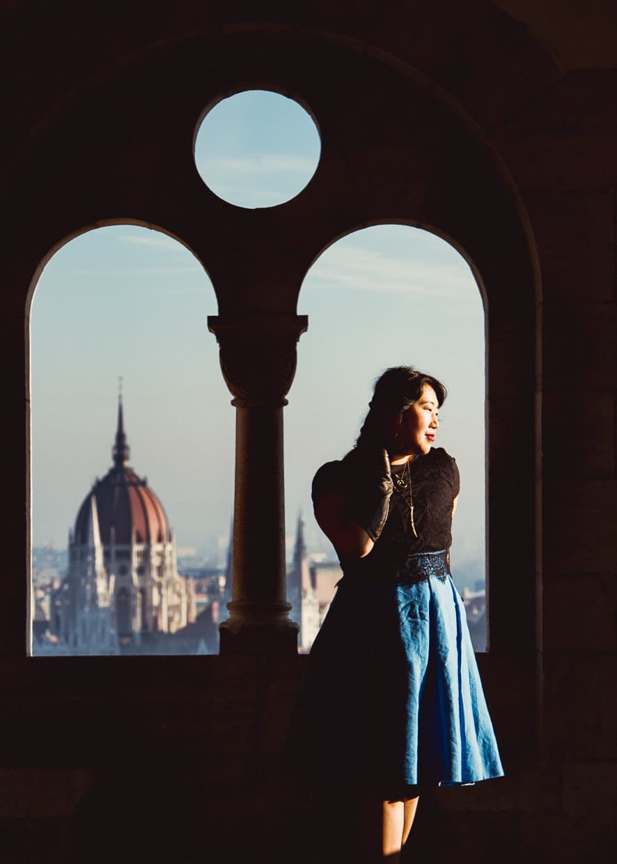 A window at the Fisherman's bastion with a view of the Parliament Building across the Danube in Budapest, Hungary.