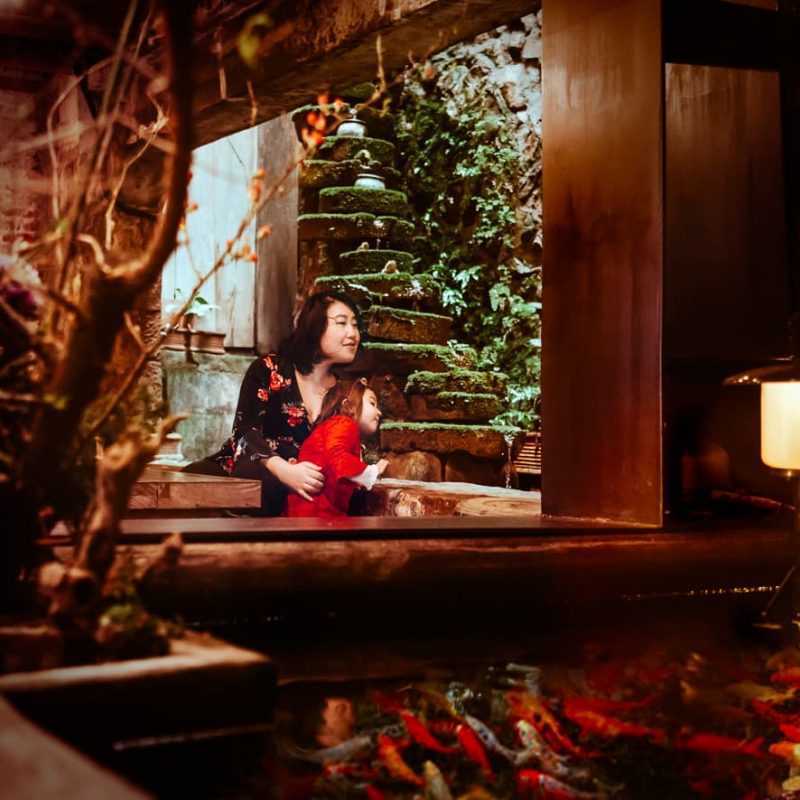 An indoor waterfall and koi pond in the Jiufen Taiwan Teahouse.