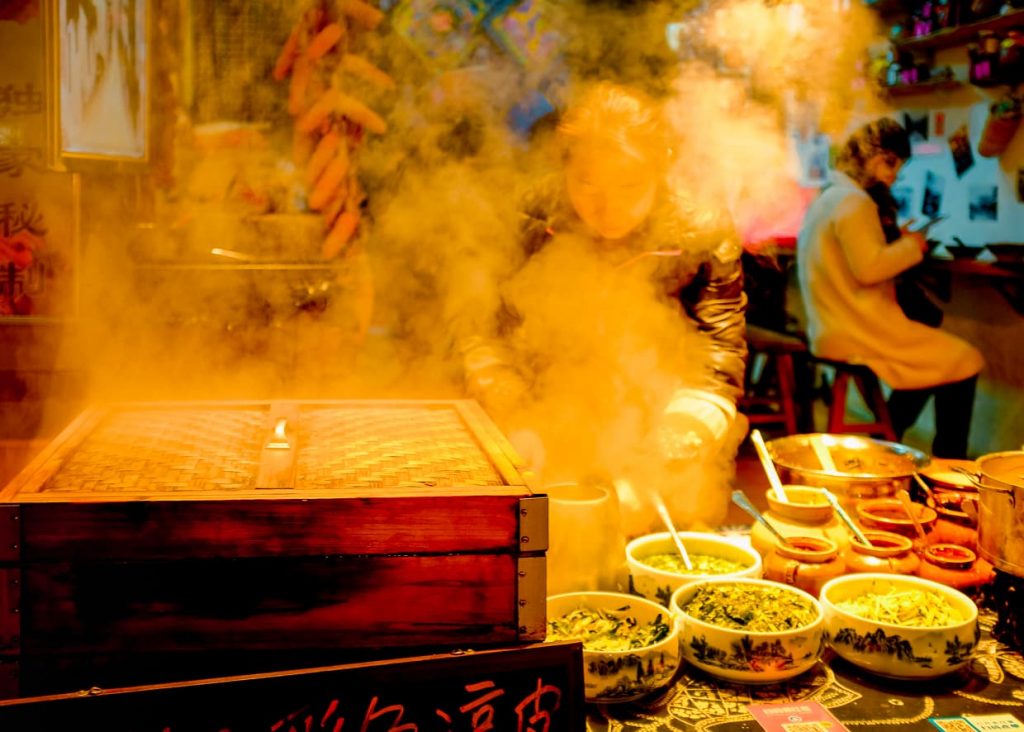 steam rising over street food in the Dali, China Old Town at night.