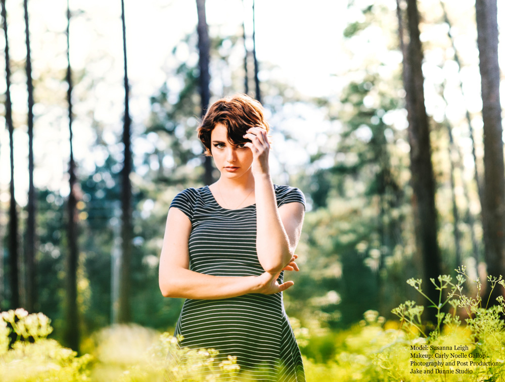 Black and white striped dress in a sunlit forest clearing