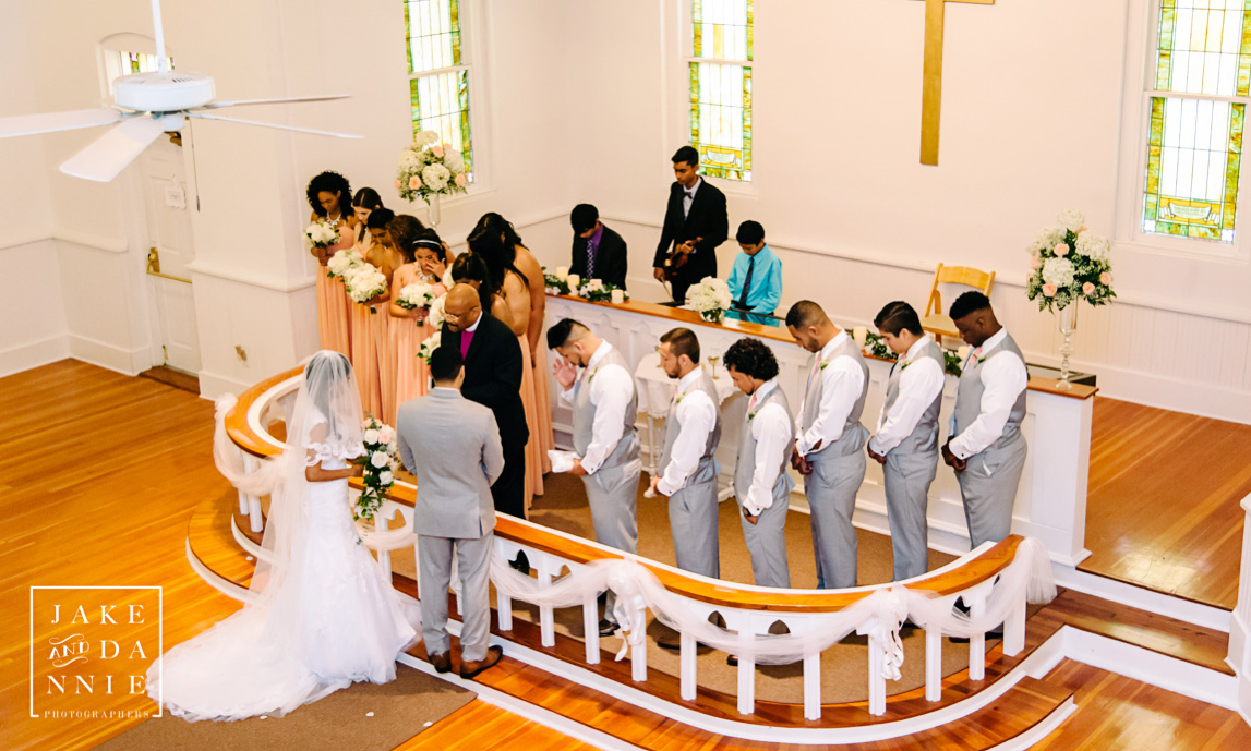 The wedding party listens to a prayer during the ceremony. 