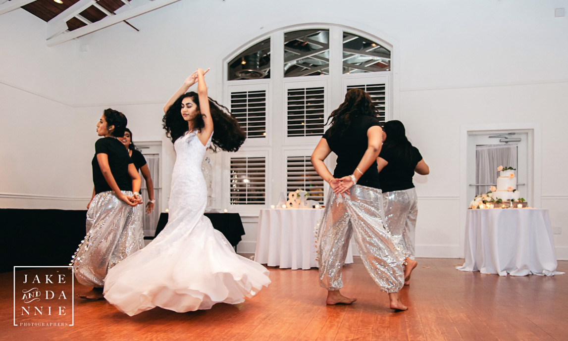 Bride and bridesmaids entertain wedding guests with an Indian Dance.