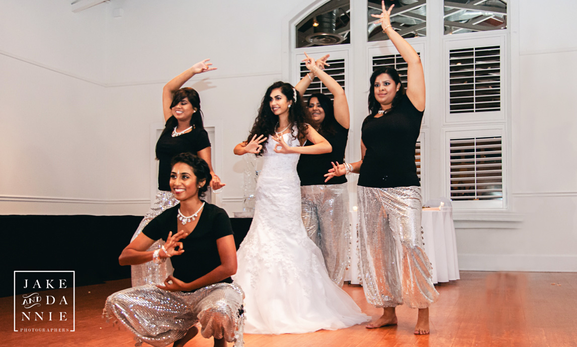 Bride and bridesmaids strike a pose at the end of their dance performance.