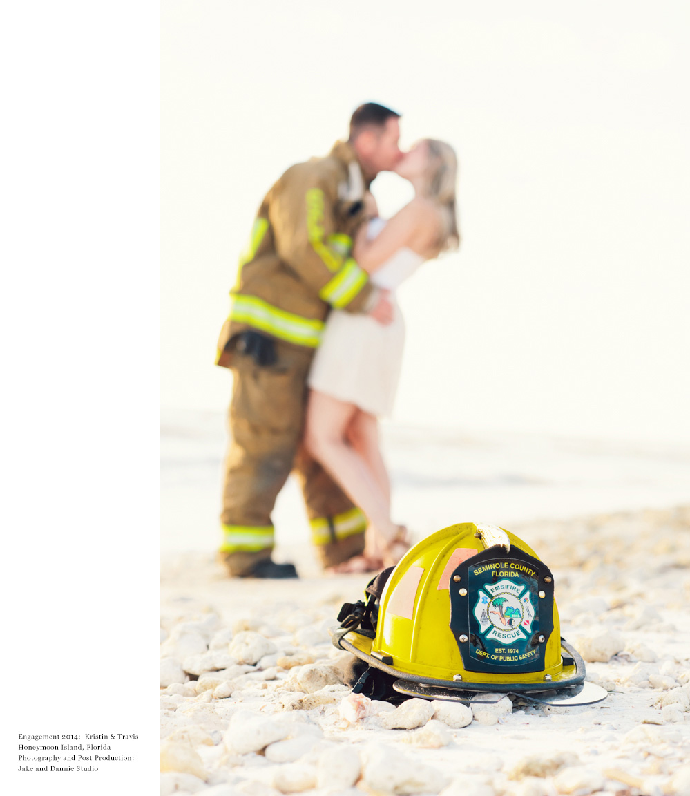 Fire helmet on the beach with couple kissing in the background