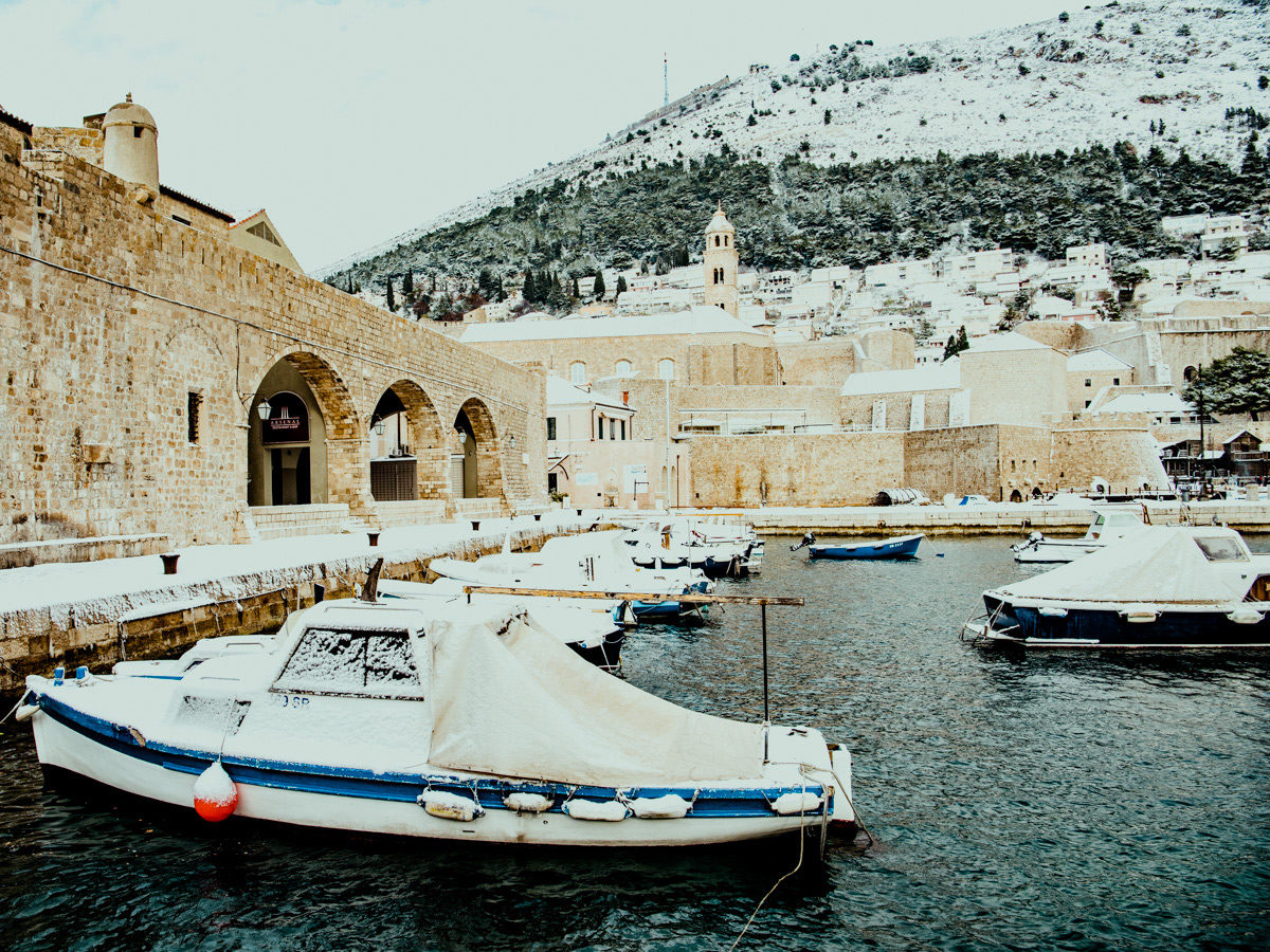 Boats covered in snow in the harbor in Dubrovnik, Croatia