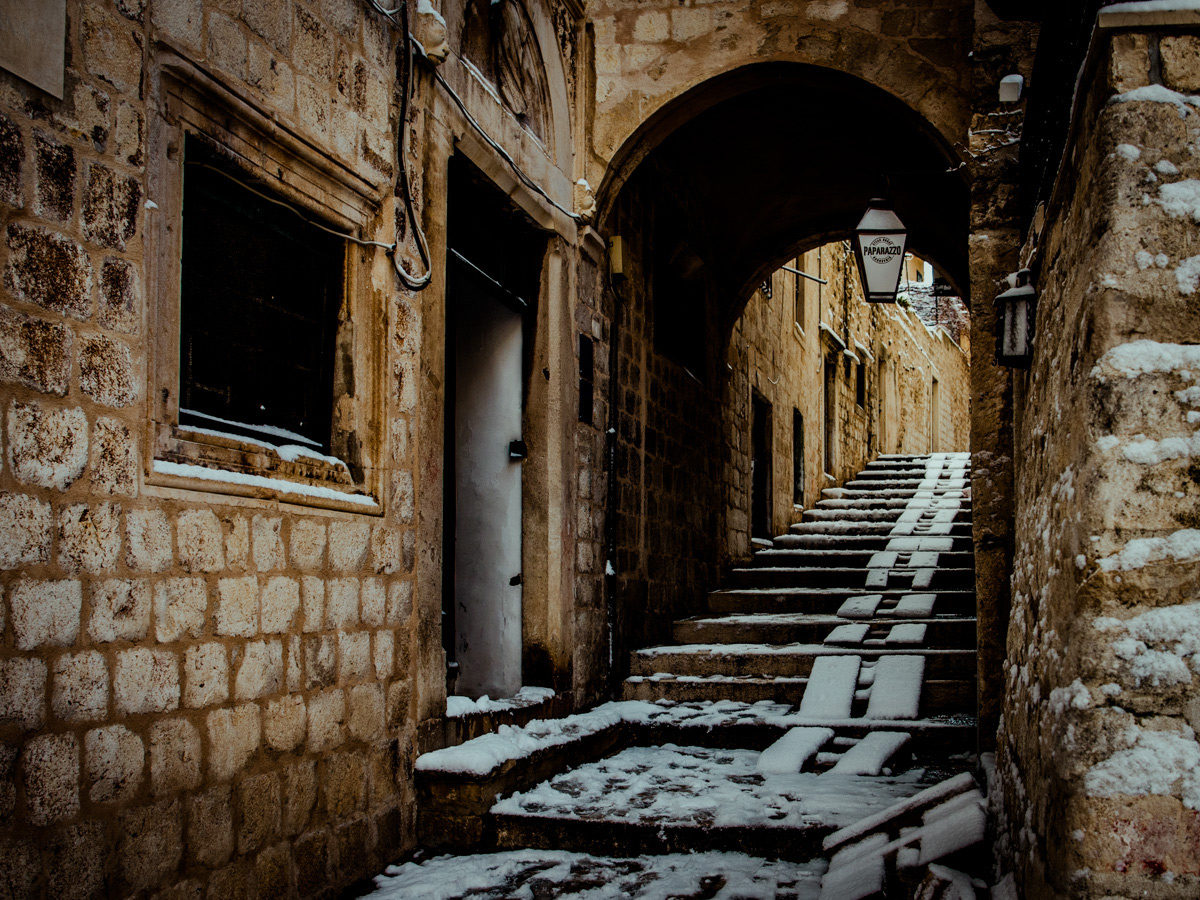 a stair filled alleyway in Dubrovnik after snow