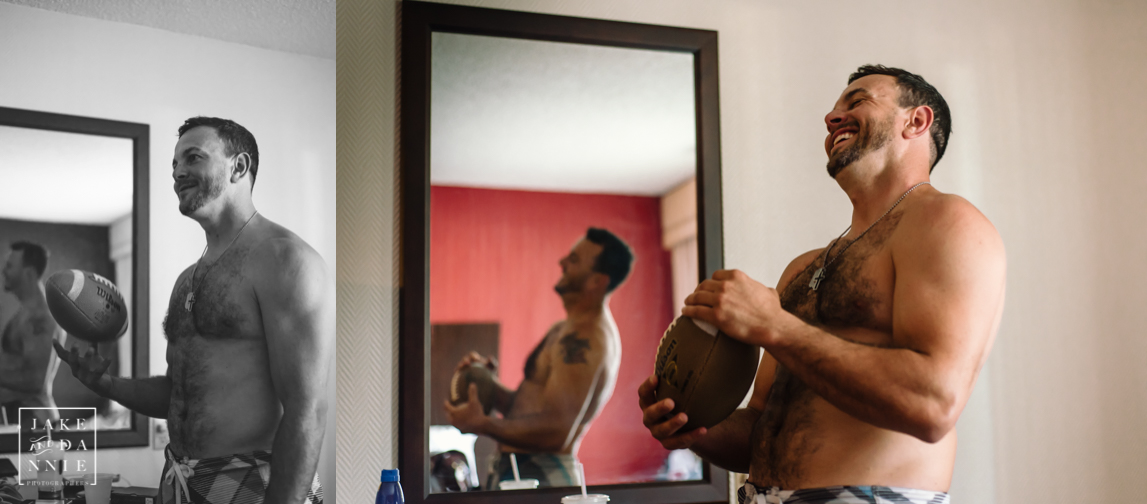 The groom laughs as he holds a football in his dressing room.