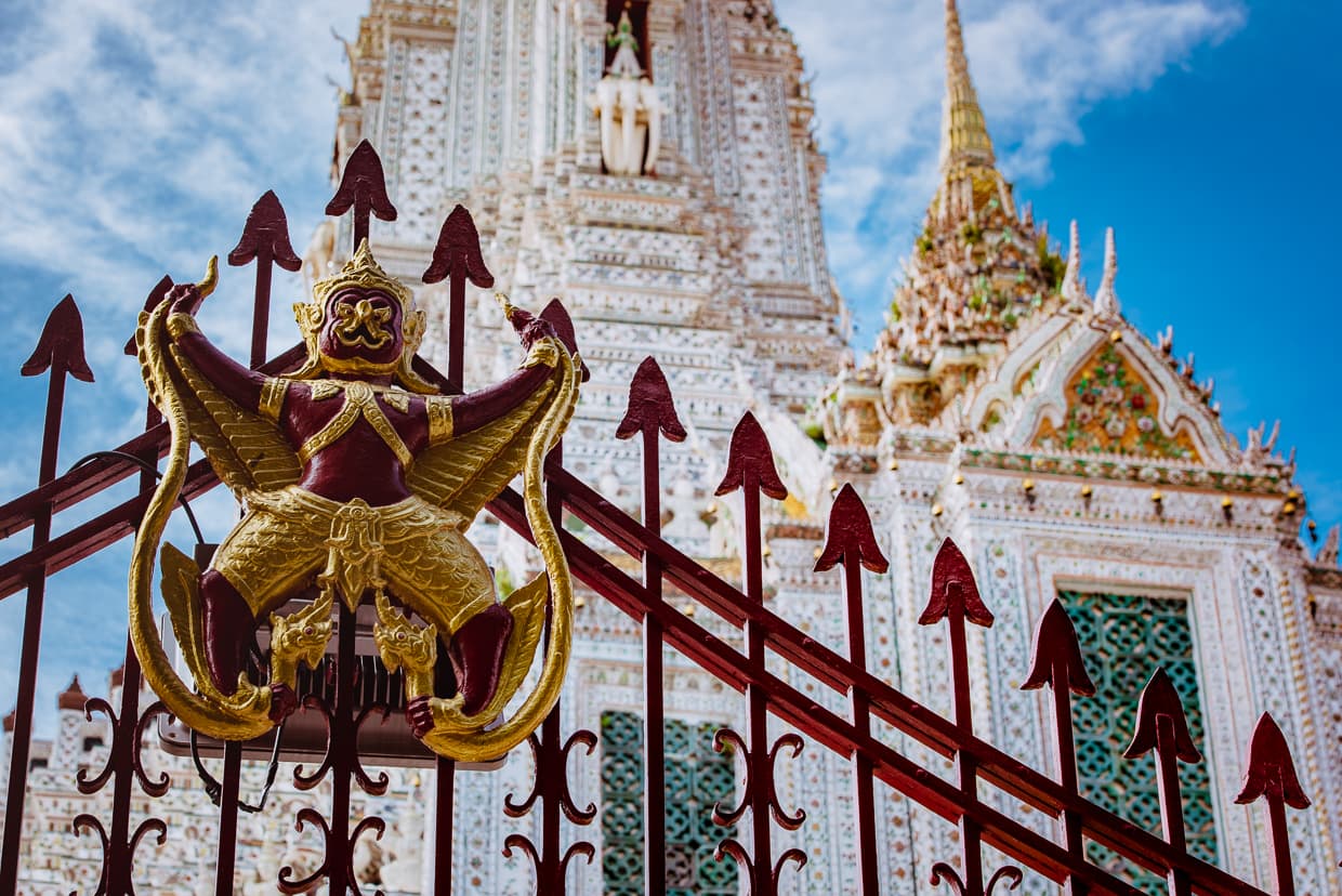 A sculpture on a fence in front of Wat Arun in Bangkok.