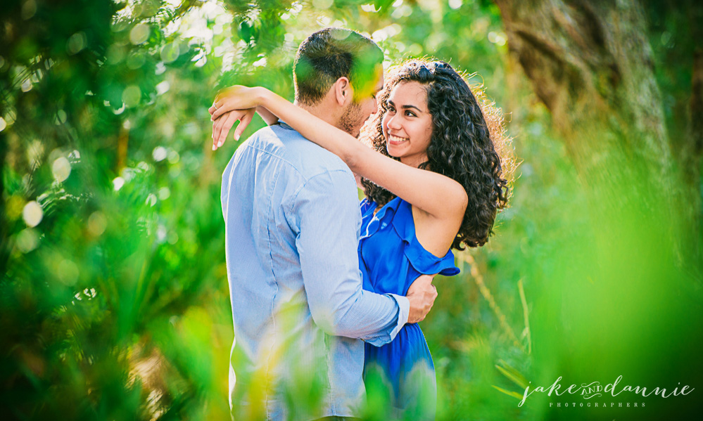 loving future bride and groom look into each others eyes during engagement session