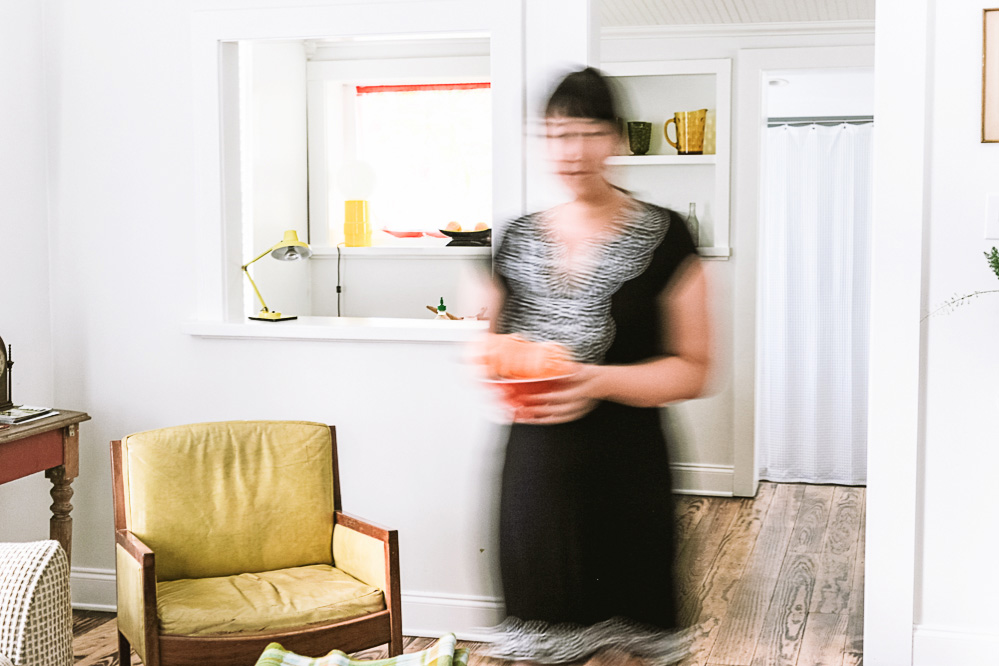 A deliberately blurred photo of me walking around the living room in a black dress on our vacation