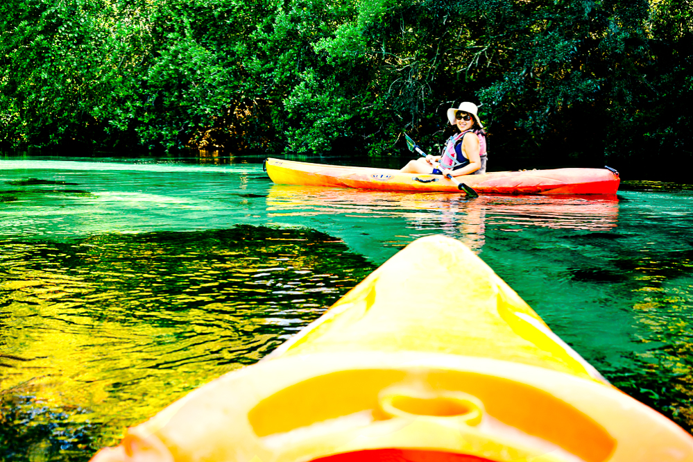 Dannie Kayaks down the Weeki Wachee River. The front of my kayak is visible in the foreground of the photo