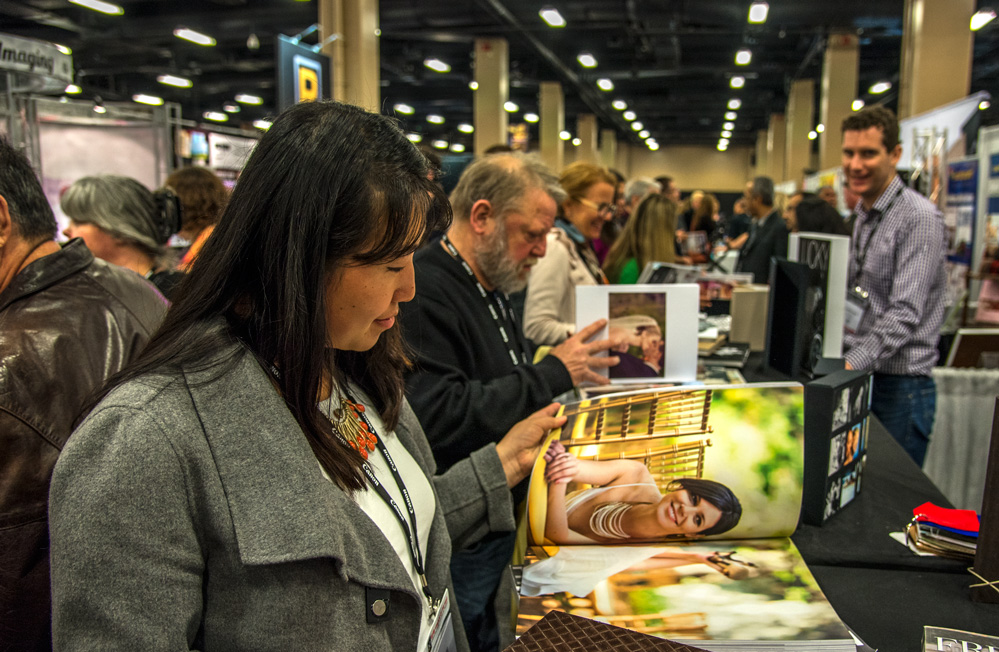 Dannie browses through sample albums on the convention floor at Imaging USA 2015 in Nashville