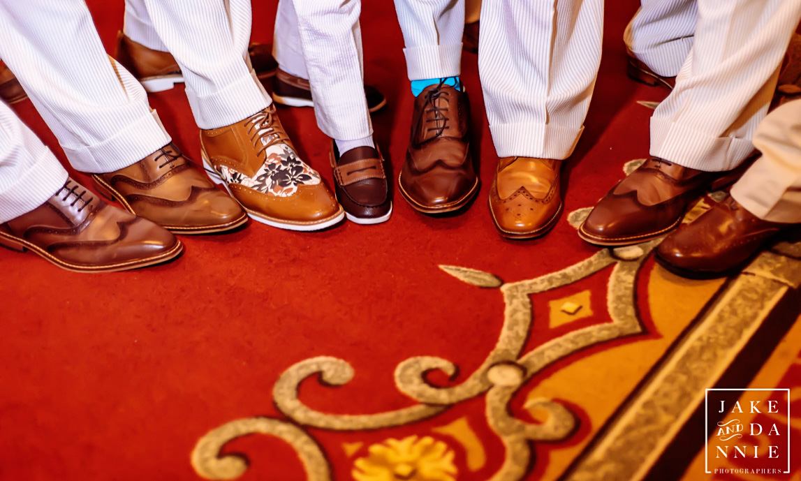The groom and groomsmen show of their shoes at T Pepins Hospitality Center in Tampa, FL