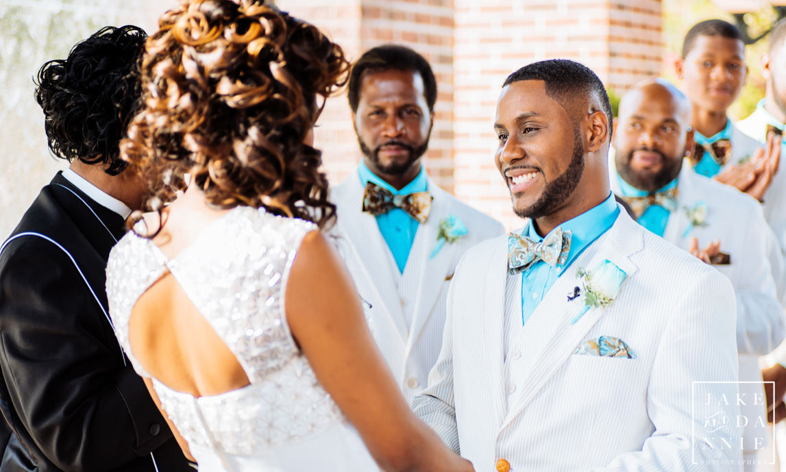 Groom smiles at his bride in Tampa, Florida