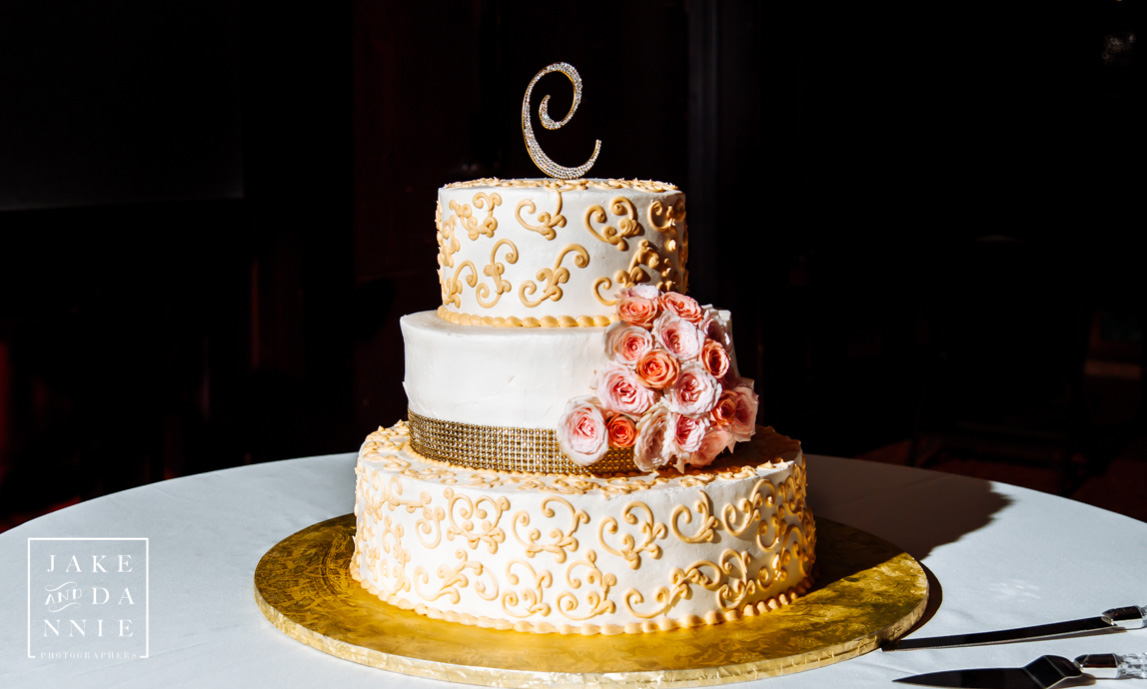 A beautiful three layer wedding cake with pink flowers