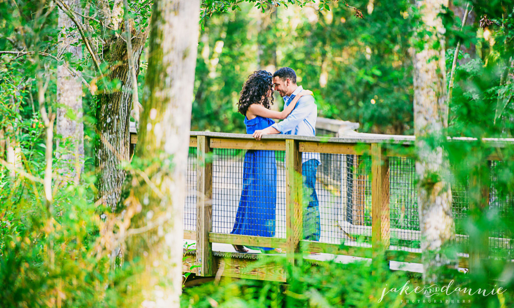 beautiful photograph of engaged couple sharing romantic moment with photographer