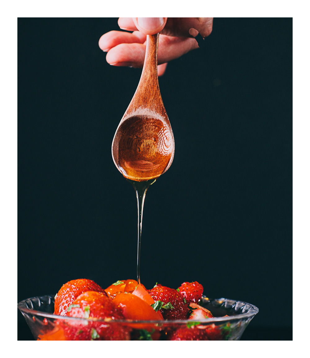 a closeup photograph of the spoonful of honey