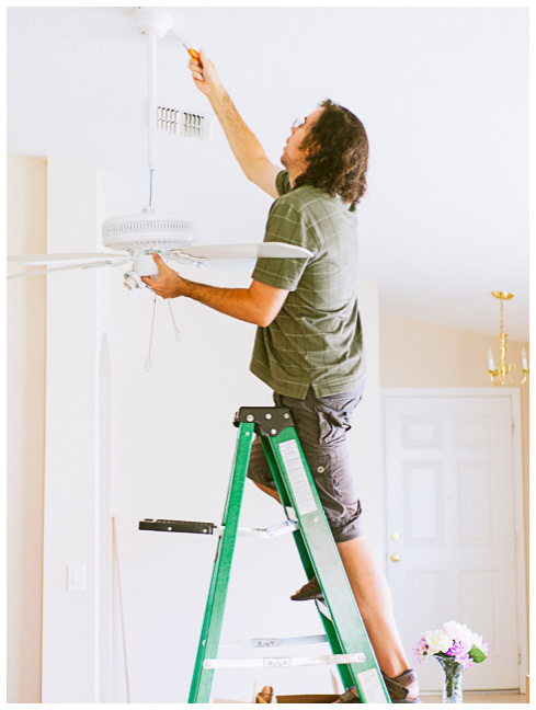 Jake almost dropping the ceiling fan as he sets up our new photo studio